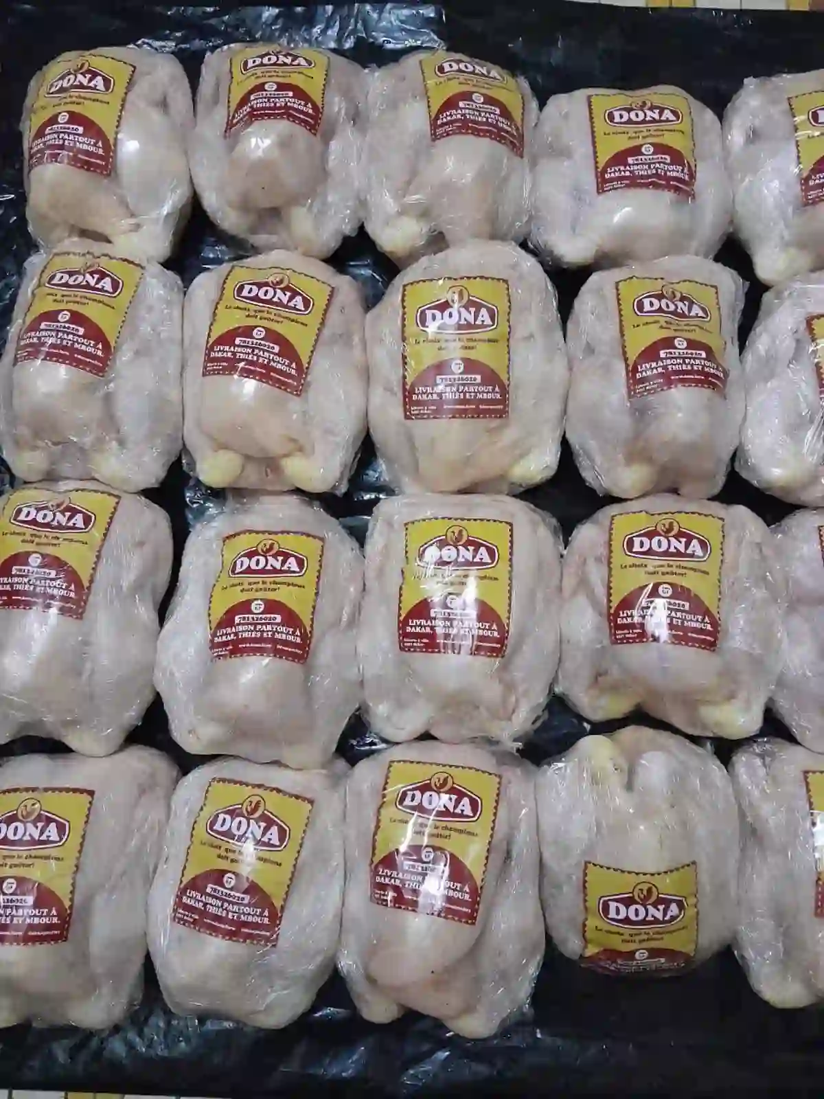 Packaged whole chickens with the Dona label